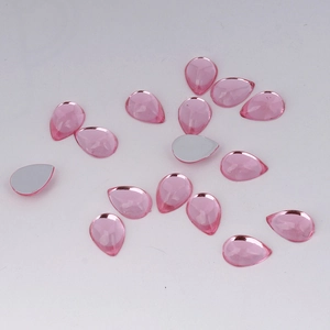 Detailed macro view of faceted pink acrylic teardrop flatback gems for DIY jewelry