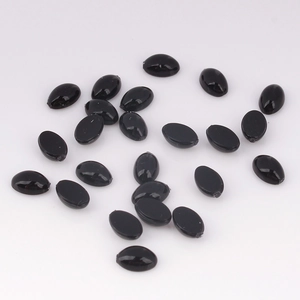Flat lay of 4x6mm black oval acrylic flatback gems for DIY jewelry and crafts
