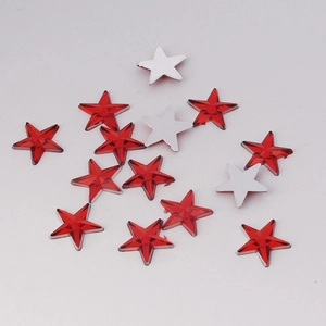 Macro detail of faceted 10mm red star rhinestones for DIY crafts and clothing decor