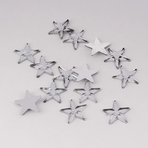 Macro shot of 10mm flatback acrylic star rhinestones with silver foil for DIY crafts