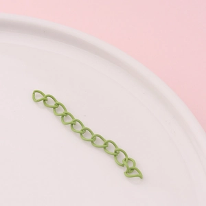 Close-up of grass green matte extension chain links for DIY jewelry and crafts