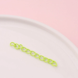 Macro shot of neon green painted metal extender chains for DIY jewelry making accessories
