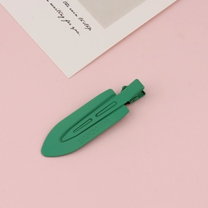 Macro shot of matte green seamless hair clip with LIANODIAN engraved text detail