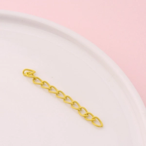 Macro detail of yellow matte metal extension chain for DIY jewelry making and crafts