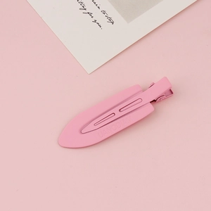 Close-up of pink matte hair clip with UANODIAM engraving and elegant duckbill structure