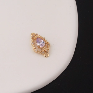 Macro shot of gold teardrop zircon pendant with hollow flower design for DIY jewelry