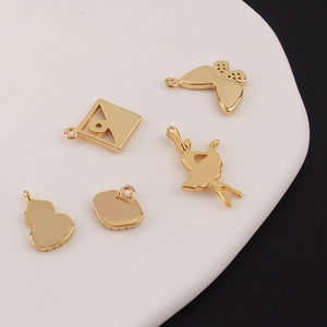 Five gold-plated brass DIY jewelry charms including ballet girl, butterfly and lock shapes