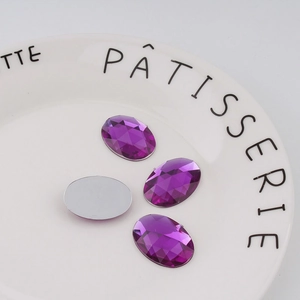 Macro detail of 18x25mm purple oval acrylic rhinestones with silver flat back base