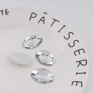Macro detail of 18x25mm oval faceted acrylic rhinestones with silver flat back base