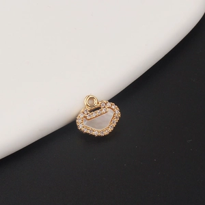 Macro detail of a gold-plated ballet girl butterfly lock pendant with white shell inlay