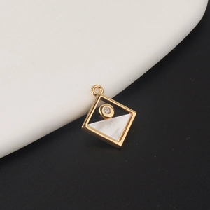 Detailed close-up of a geometric rhombus pendant with gold plating and zircon inlay