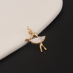 Detail of ballerina pendant in gold-plated copper with white shell and zircon accents
