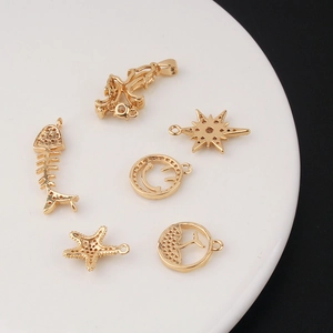 Assorted gold plated starburst and dolphin tail pendants for DIY jewelry making