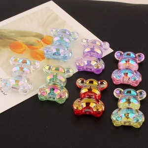 Macro detail of seven colorful iridescent aurora resin bears for DIY jewelry making