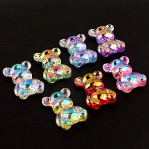 Macro detail of seven iridescent 3D bear charms with colorful pearlescent finish