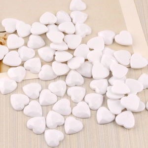 Macro shot of 12mm white acrylic heart flatback cabochons with glossy finish