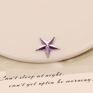 Macro detail of 20mm purple star-shaped acrylic crystals with precise multi-faceted cutting