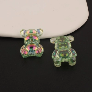 Detail showing two translucent iridescent bear charms with shiny metallic pearlescent finish