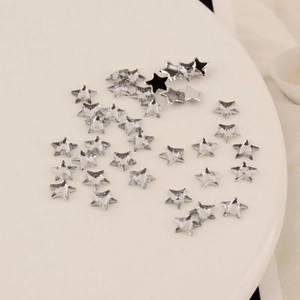 Detailed macro view of 6mm star shaped acrylic flatback rhinestones for DIY nail art