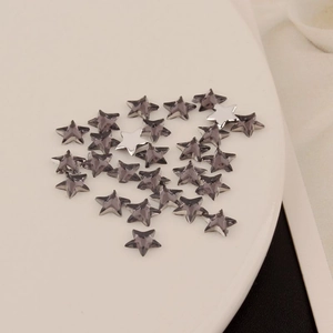 Macro shot of 6mm star-shaped faceted acrylic flatback crystals for DIY jewelry and nail art