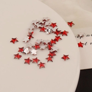 Macro detail of red acrylic 6mm star rhinestones for DIY nail art and phone cases