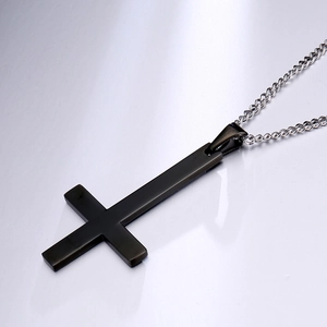 Detailed view of a sleek black Saint Peter inverted cross pendant on a silver chain