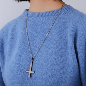 Detailed view of dark grey matte St. Peter inverted cross pendant on a link chain