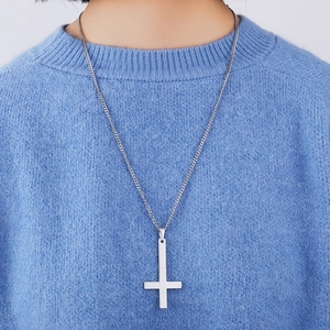 Silver stainless steel St. Peter inverted cross necklace worn on blue sweater