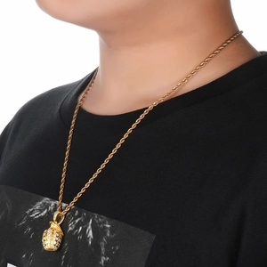Nahaufnahme eines goldenen Hip-Hop Granaten-Anhängers mit Diamanten und Twist-Kette