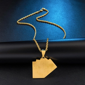 Detailed view of gold industrial rope chain necklace with a textured square pendant