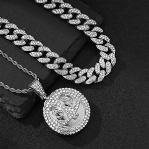 Close-up of hip-hop silver plated Cuban chain and dollar sign smile pendant with crystals