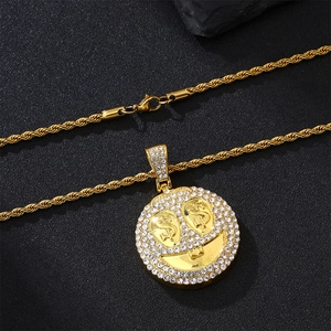 Detail of gold Cuban chain and pavé crystal smiley face pendant with dollar sign eyes