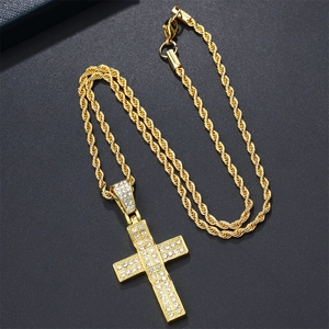 Detailed close-up of golden iced-out cross pendant with a thick rope chain necklace