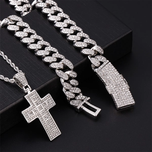 Hip hop jewelry set featuring iced-out silver cuban chain and cross pendant on black box