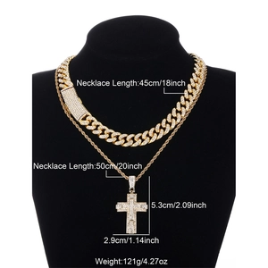 Detail of hip hop jewelry set with gold iced out cuban link and cross pendant