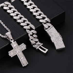 Detail shot of silver hip hop jewelry set with crystal cross pendant and cuban chain