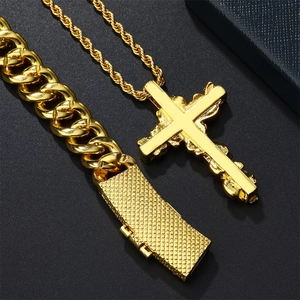 Golden hip hop cross pendant necklace with chunky cuban link bracelet on dark box