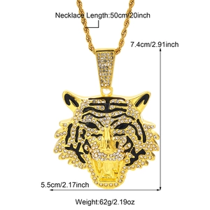Golden tiger head pendant necklace with rhinestones and black enamel detail on rope chain