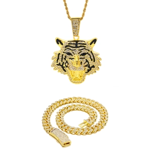 Detailed view of hip hop tiger pendant with cuban chain set in gold and zircon finish