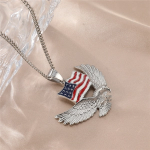 Detail of silver stainless steel eagle pendant with US flag on champagne silk background