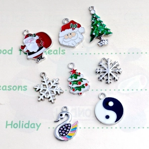 Detailed macro view of assorted enamel Christmas charms with snowflakes and trees