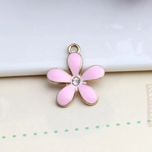Detailed close-up of a pink enamel five-petal flower pendant with sparkling diamond center