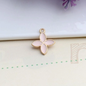 Detail shot of light pink clover charm with golden alloy edges and hanging ring for DIY