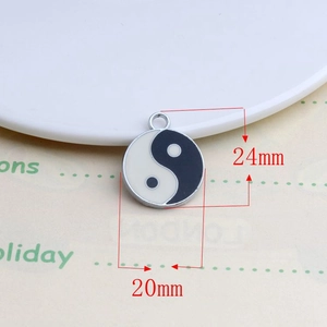 Detail of Yin Yang enamel pendant charms with precise 24mm height measurements