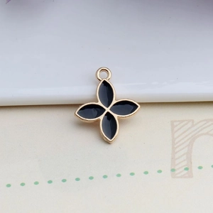 Detail of four-leaf clover pendant in black enamel with golden alloy plating for DIY jewelry