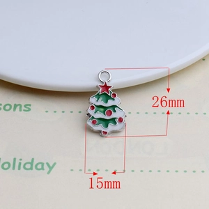 Detail of green enamel Christmas tree pendant with red star and 26mm x 15mm dimensions