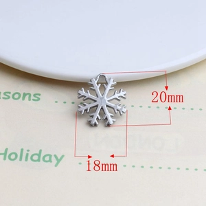 Macro shot of a 20mm by 18mm silver alloy snowflake pendant for DIY jewelry projects