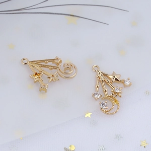 Detail of gold-plated crescent moon and star pendants with white zircon for DIY jewelry