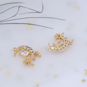 Macro shot of gold crescent moon charms with stars and sparkling zircon stones