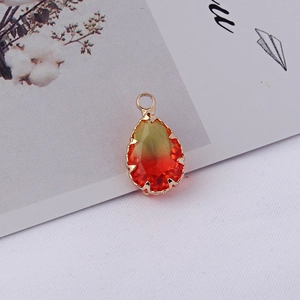 Détail d'un pendentif en cristal en forme de goutte d'eau avec bordure dorée polie